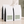 Four 5 lb white coffee bags with black side panels and pale green labels, arranged on a beige surface against a textured wall with soft shadow overlays. The front bags show the text Costa Rica Finos Las Torres.