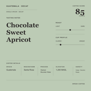 A minimalist coffee label design for 'Guatemala Decaf' featuring a muted sage green background, black typography, and a coffee score of 85 points.