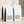 Four white bulk 5 lb. coffee bags with black side panels and pale green labels, arranged on a beige surface against a textured wall with soft shadow overlays. For The 50/50 blend.