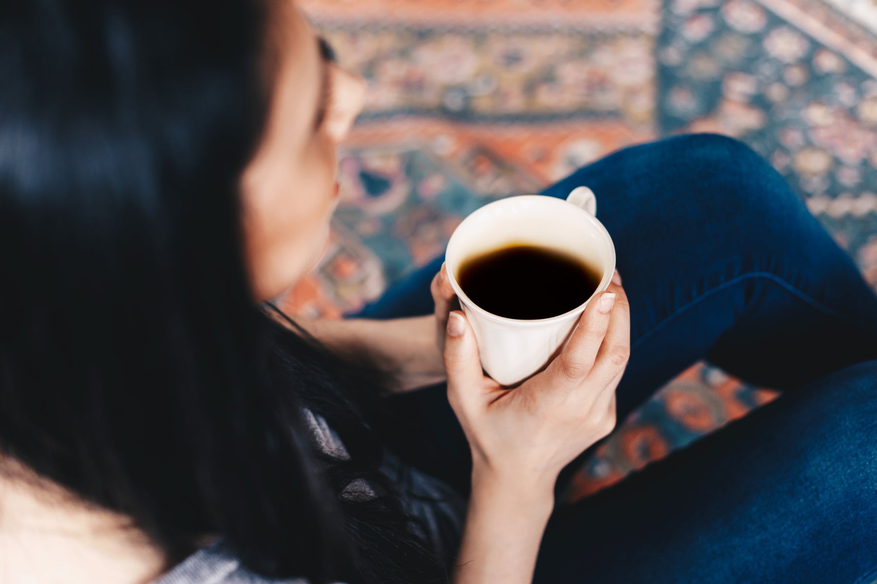 A Spesh coffee bag with a brewed cup of coffee